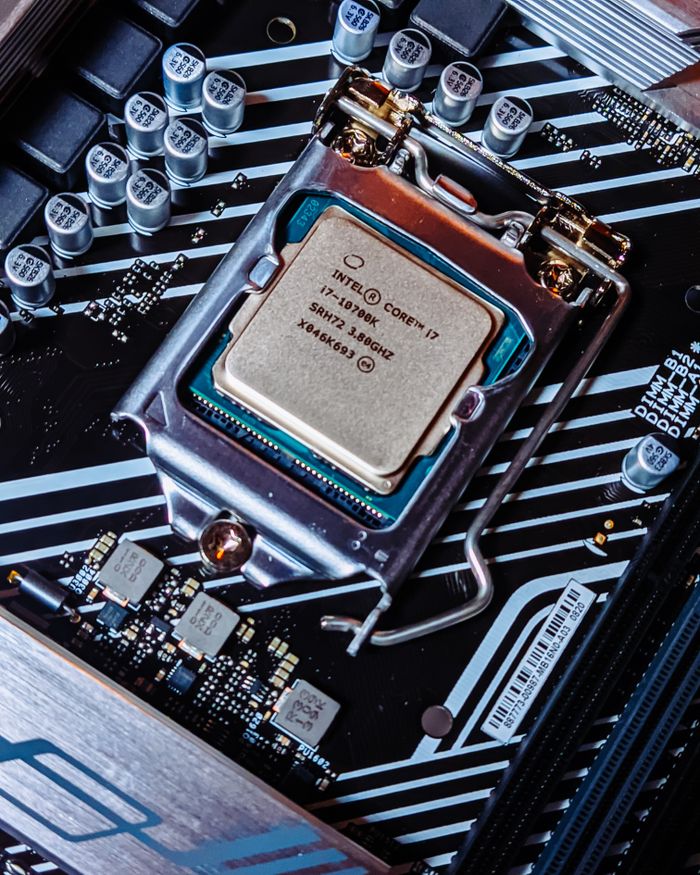 services-03 Detailed view of an Intel i7 processor installed on a computer motherboard.