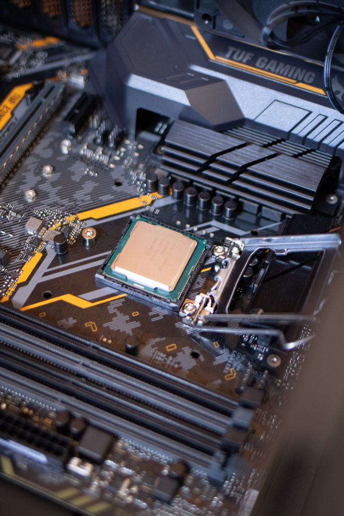 services-02 Detailed view of a motherboard with an exposed CPU, showcasing technology components.
