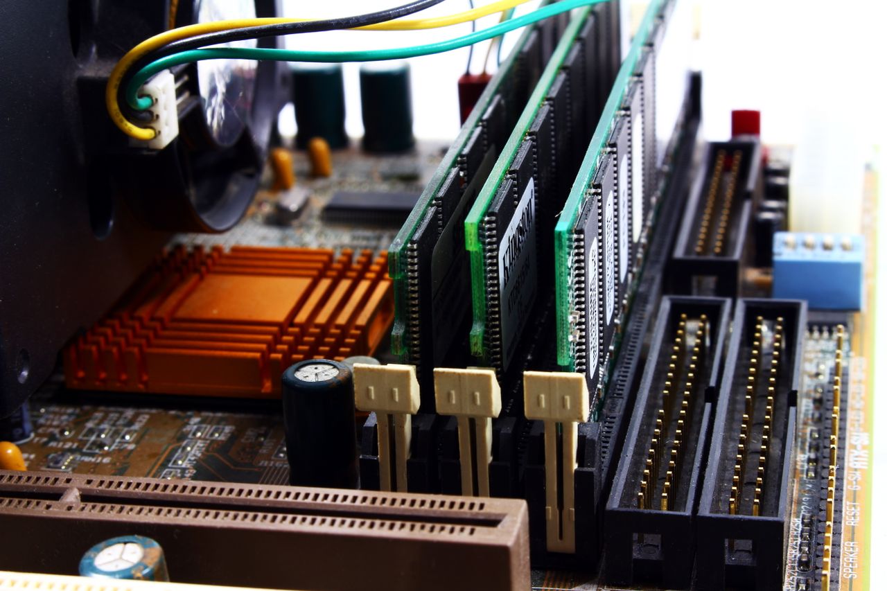 heros-img Detailed view of computer motherboard featuring RAM, chipset, and wiring.